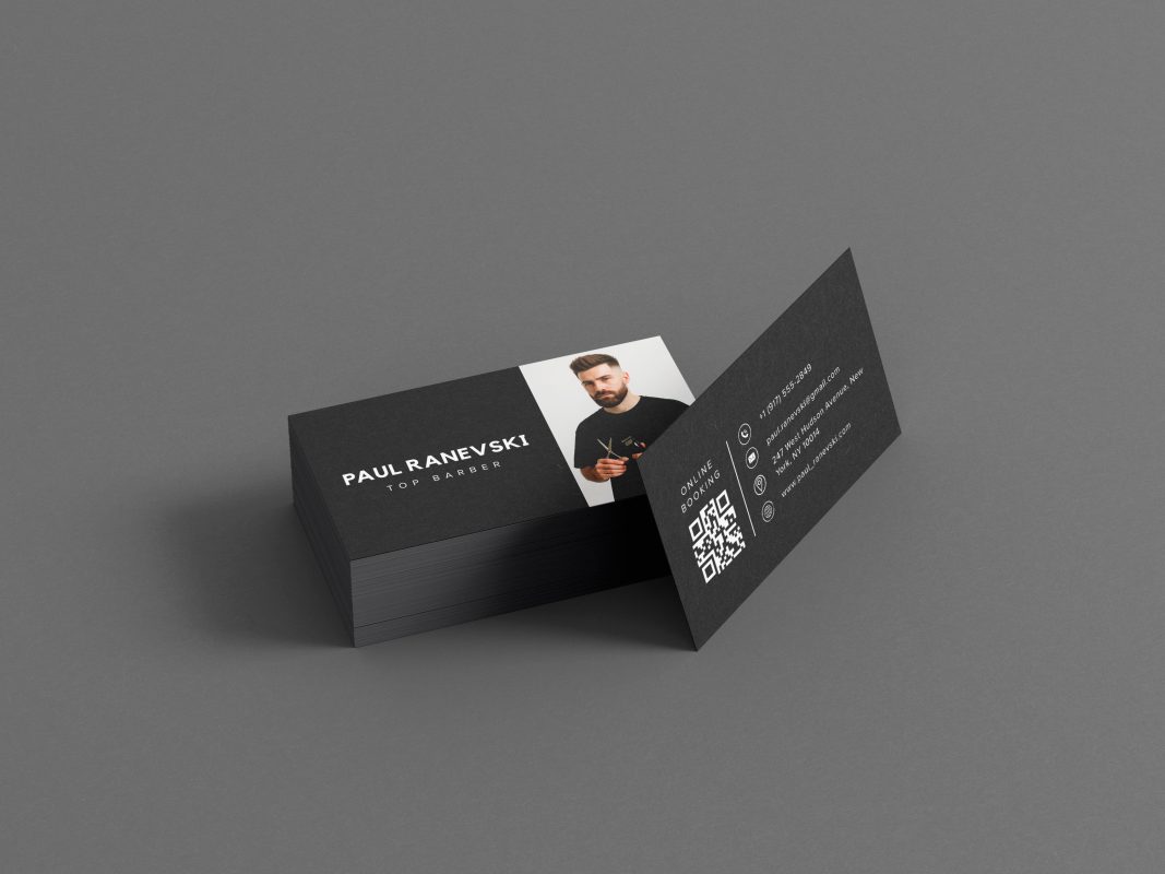 Double-sided minimal black freelance barber contact card mockup showing photo and name front with large QR code and contact details reverse
