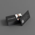 Double-sided minimal black freelance barber contact card mockup showing photo and name front with large QR code and contact details reverse
