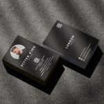 Double-sided minimal black barber business card template mockup showing shop branding front and barber photo with QR code reverse