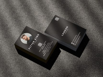 Double-sided minimal black barber business card template mockup showing shop branding front and barber photo with QR code reverse