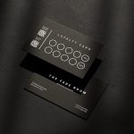 Double-sided minimal black matte barber reward card template mockup showing tiered visit discount system and dual QR codes
