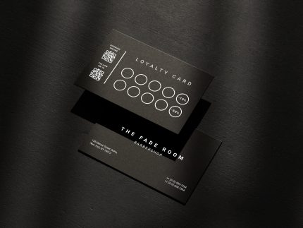 Double-sided minimal black matte barber reward card template mockup showing tiered visit discount system and dual QR codes