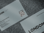 Close-up of grey minimal barbershop staff business card template showing shop logo, barber name and QR booking code