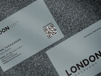Close-up of grey minimal barbershop staff business card template showing shop logo, barber name and QR booking code