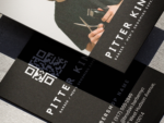 Close-up of minimal black solo barber name card template showing the oversized QR booking code on the reverse face