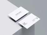 Two sides of a clean white barber business card featuring minimalist black text and a QR code.
