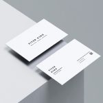Two sides of a clean white barber business card featuring minimalist black text and a QR code.
