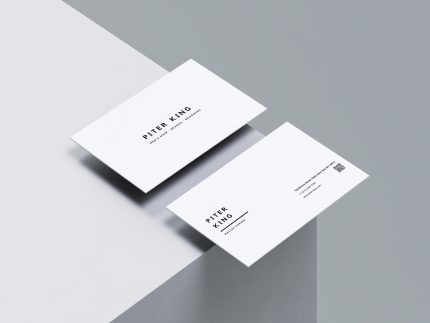 Two sides of a clean white barber business card featuring minimalist black text and a QR code.
