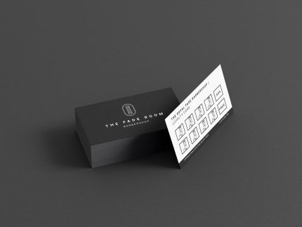 White reverse of the barbershop stamp card template showing clipper icon visit slots, 50% at visit 5 and free cut at visit 10