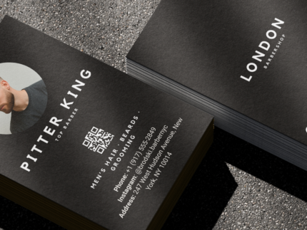 Close-up of double-sided minimal black barber business card template showing barber photo, name and second QR code on the reverse
