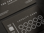 Close-up of minimal black matte barber discount reward card template showing the 5th and 10th visit discount milestones