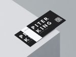 Black and white barber name card template showing large barber name on front with QR code and contact details on back, flat lay mockup