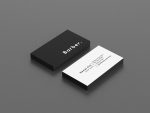 Black and white personal barber business card template showing bold BARBER text on front and contact details on back, flat lay mockup