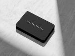 Front face of minimalist barbershop business card template showing only the shop name in clean spaced typography on black background