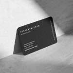 Back face of text-only barbershop business card showing shop name, barbershop label, website, address, phone number and Instagram handle in column layout