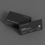 Black double-sided barber business card template showing shop name on front and master name with QR code on back, Canva editable