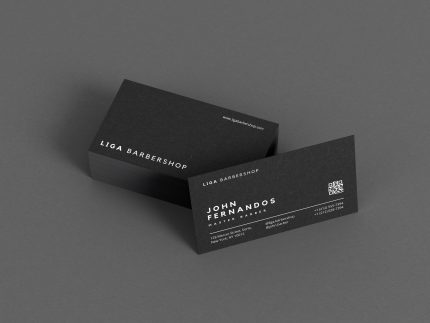 Black double-sided barber business card template showing shop name on front and master name with QR code on back, Canva editable