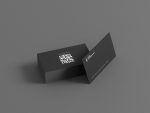 Two-sided minimal barbershop booking card mockup showing shop name and barber pole icon front with full oversized QR code reverse