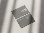 Reverse of the minimal grey barbershop card template showing barber name, title, website, address, phone and Instagram fields