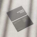 Reverse of the minimal grey barbershop card template showing barber name, title, website, address, phone and Instagram fields
