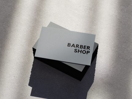Use case graphic showing the ultra-minimal grey barbershop card template suits loft, concrete, and industrial aesthetic barbershops